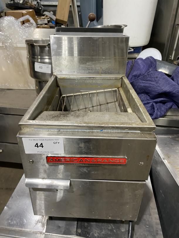 American Range commercial stainless steel gas fryer on legs, pre-owned. Features wire basket, visible wear, and brand logo.