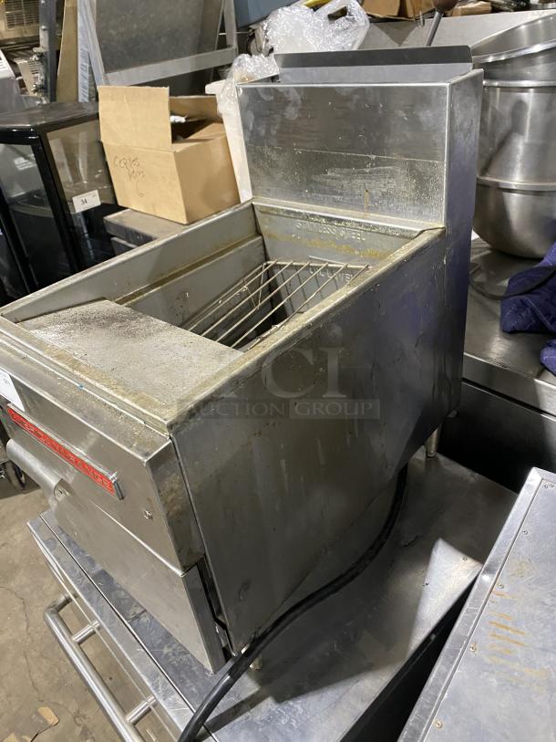 American Range commercial stainless steel gas fryer on legs, showing wear. Visible label reads "American Range."