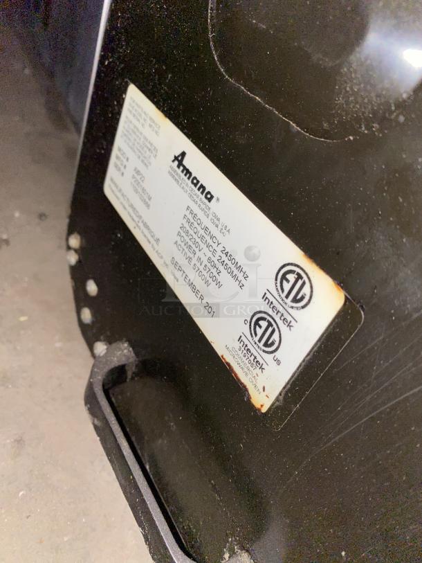 Amana Commercial stainless steel microwave oven, 208-230V, shown with label detailing model and electrical specifications.