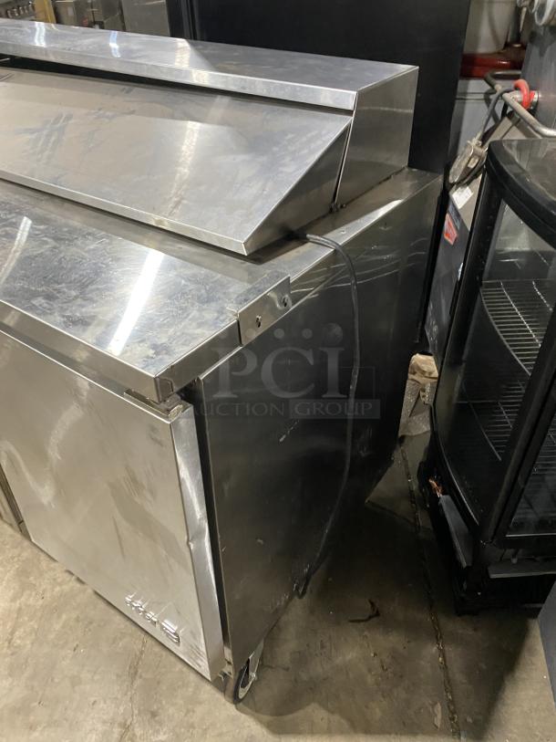 Asber APTS7218 stainless steel 3-door prep table fridge with poly-coated wire rack, on casters. Model: APTS 72 18 HC.