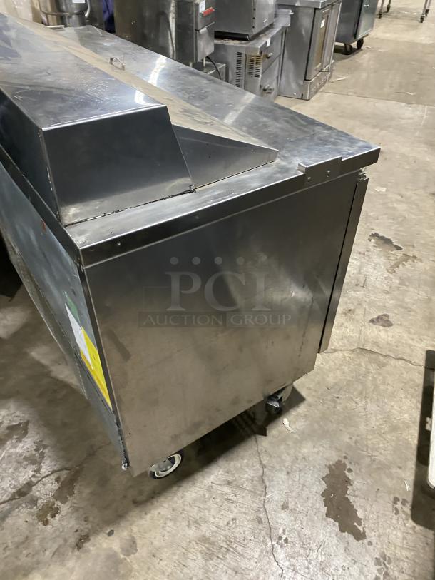 Asber APTS7218 3-door stainless steel sandwich prep table refrigerator on casters, with poly coated wire rack, 115V, good condition.