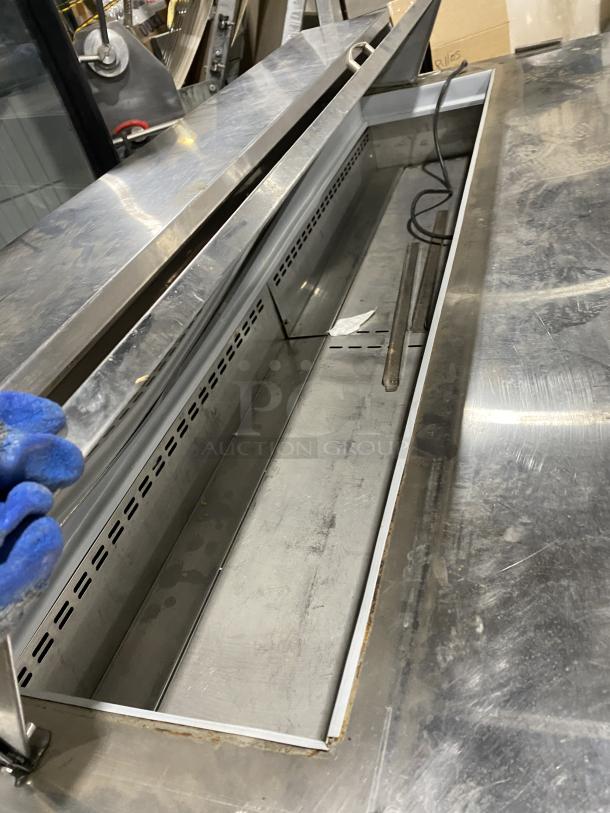 Asber APTS7218 3-door stainless steel prep table refrigerator, features poly-coated wired rack, on casters, in good condition.