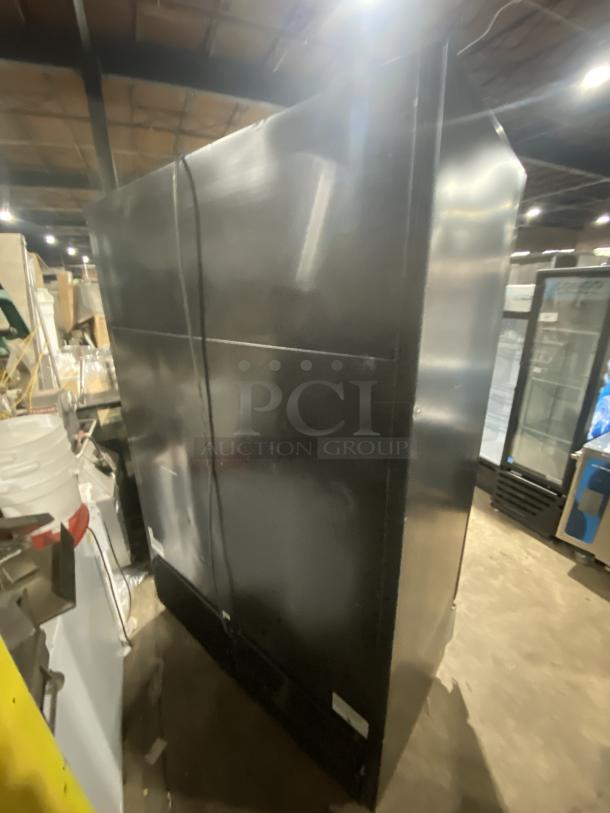 True GDM-49F-HCX-TSLO1 black double glass swing door merchandiser freezer with poly-coated wire racks, used.