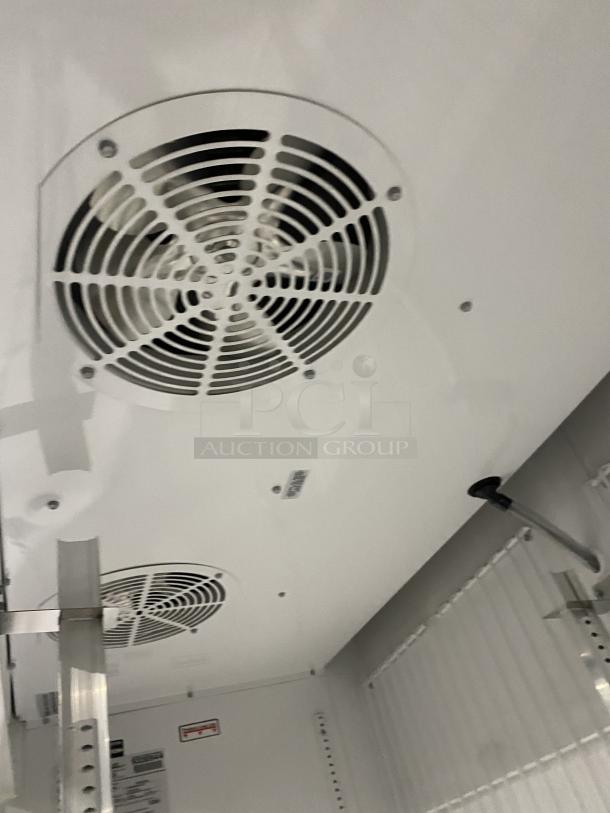 True commercial freezer interior, model GDM-49F-HCX-TSLO1, features dual fans and poly coated rack, SN: 9330944.