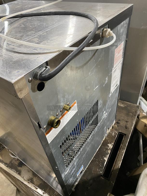 Hoshizaki KM-660MRJ commercial stainless steel ice maker, electric powered, 115V, visible hoses, labels with model and warnings.