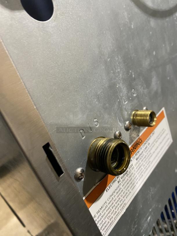 Hoshizaki KM-660MRJ ice maker, stainless steel, electric powered, visible discharge connections, model and safety label.