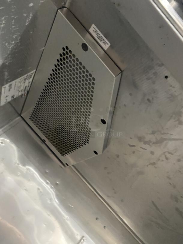 True Commercial Series stainless steel refrigerator interior, model STG2R-2G. Features vented panels and serial number tag.