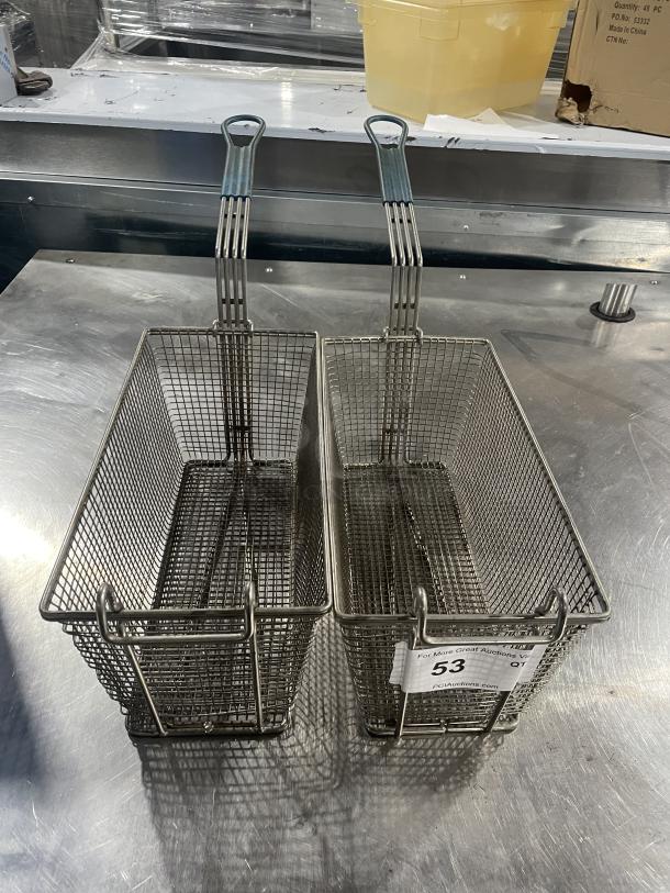Two metal deep fryer baskets with sturdy handles, used condition, auction tag showing lot number 53.