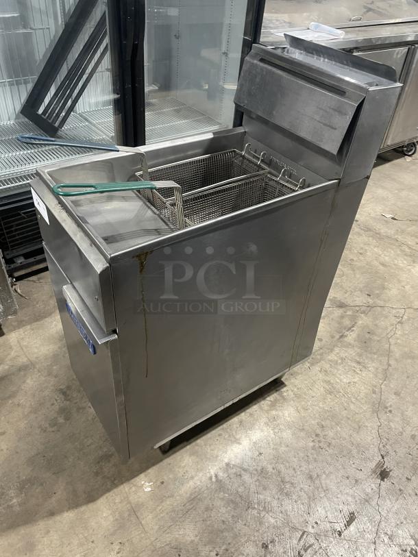 Imperial commercial stainless steel deep fat fryer, natural gas powered, with back splash, basket hanger, and on legs.