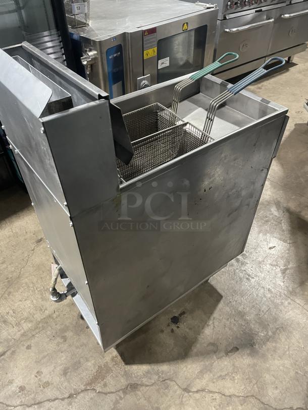 Imperial commercial stainless steel deep fat fryer with back splash, basket hanger, on legs, natural gas powered, used condition.