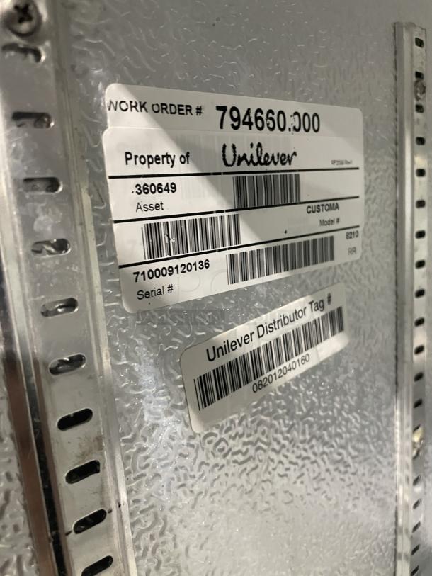 Good Humor countertop merchandiser freezer, Model 8210, white powder-coated, with poly-coated wire rack, and visible Unilever asset tags.