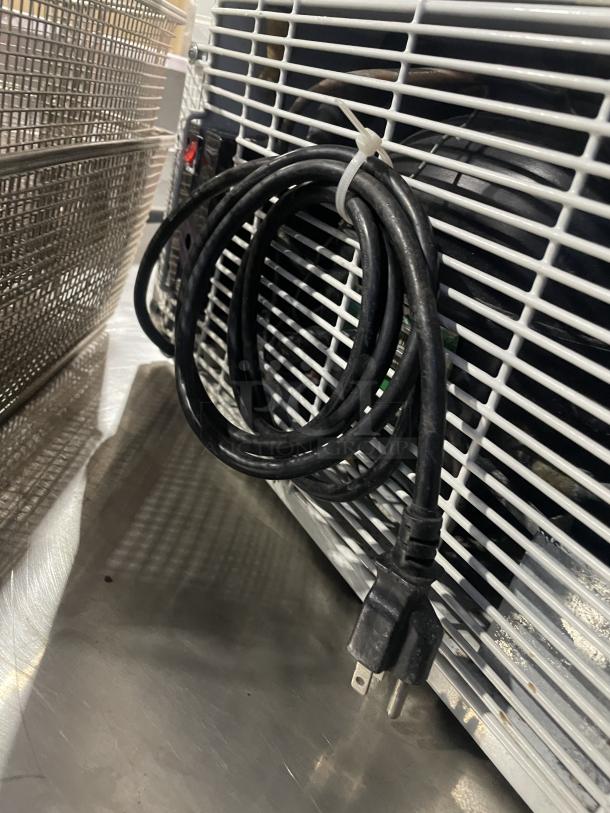 Good Humor countertop merchandiser freezer, model 8210. Features white powder coating, poly-coated wire rack. Serial number 710009120136.