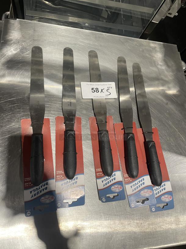 Winco Winware TKPS-9 bakery spatulas, new with black grip handles, displayed in packaging. Set of five.