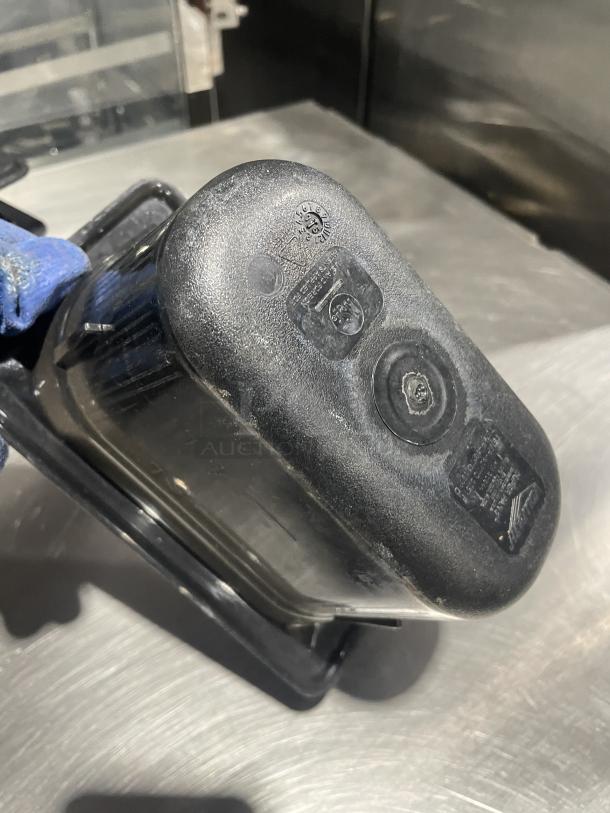 Commercial black plastic food pan, durable, lightly used, with visible measurement markings and certification labels.