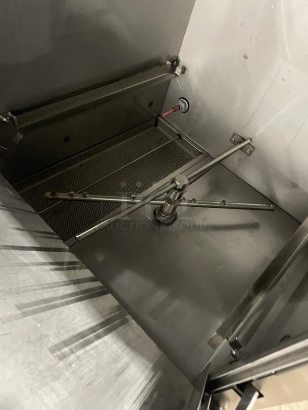 Jackson Avengerht stainless steel under-counter dishwasher with dish rack, visible interior mechanism, model SN: 13F282915.