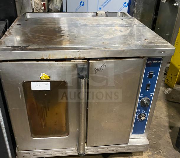 Alto-Shaam commercial stainless steel oven, natural gas powered, with wired rack, SN: 710358-002, on casters, used condition.