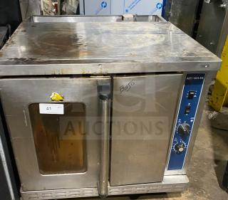 Alto-Shaam commercial stainless steel oven, natural gas powered, with wired rack, SN: 710358-002, on casters, used condition.