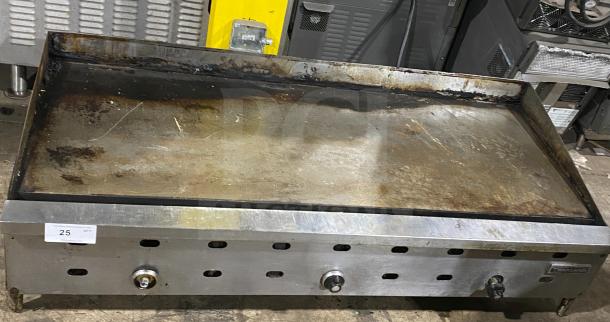 Garland stainless steel commercial countertop griddle on legs, used condition, visible control knobs and vent slots.