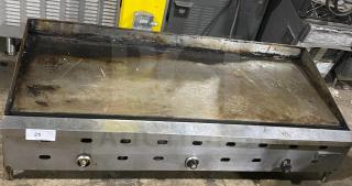 Garland stainless steel commercial countertop griddle on legs, used condition, visible control knobs and vent slots.