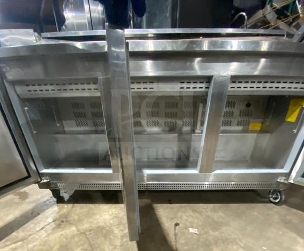 Asber APTS7218 3-Door Stainless Steel Sandwich/Salad Prep Table Refrigerator with poly-coated wired rack, on casters.