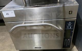 Amana commercial stainless steel microwave oven, 208-230V, digital controls, model AXP. Slightly worn, auction tag visible.