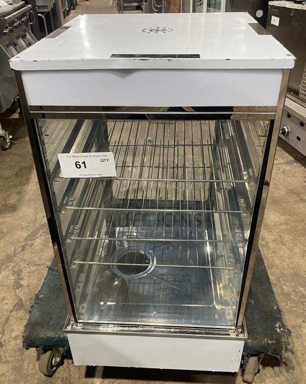 Commercial stainless steel electric bun steamer with five layers, glass door, and display warmer. Visible inventory tag.