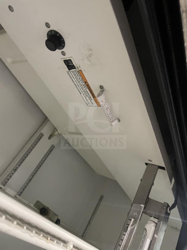 Beverage-Air MT45 commercial refrigerator interior, showing adjustable shelving system and thermostat control.