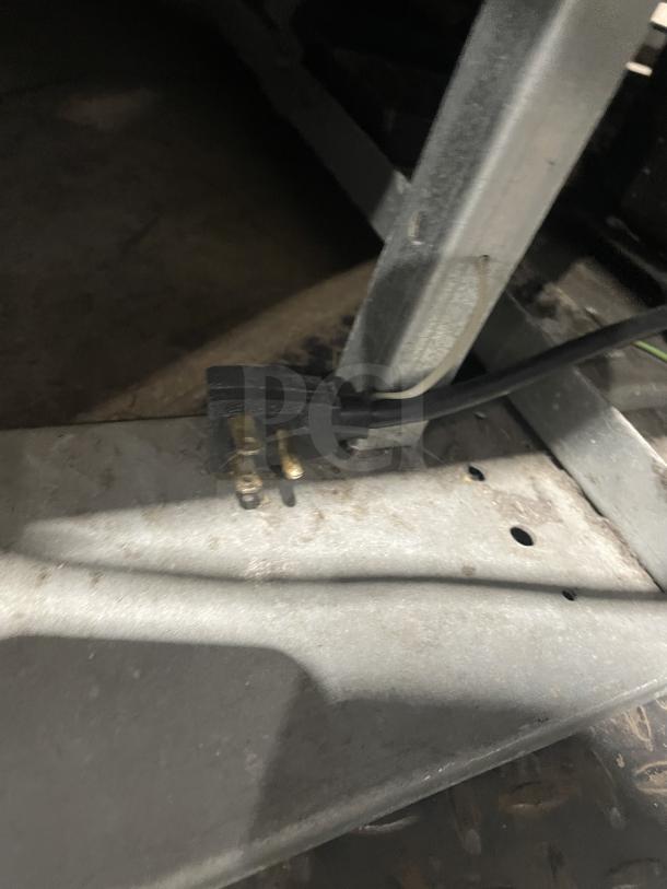 Close-up of the power plug for a Beverage-Air MT45 commercial refrigerator, showing the three-prong connection.