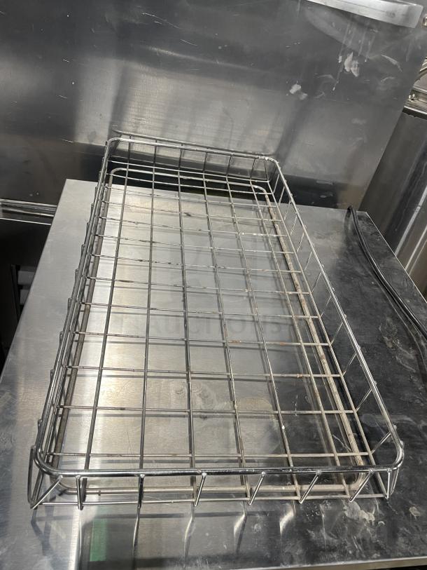 Commercial chrome-plated wired rack for bagels/pastries, full-size, durable, in used condition with some surface marks.