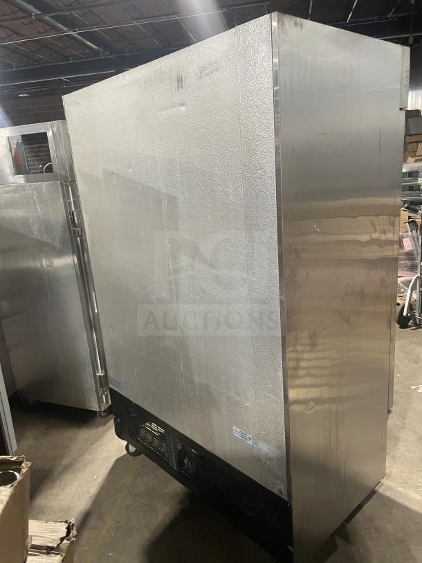 Kelvinator KCBM48RSE-HC stainless steel 2-door commercial freezer, poly coated racks, on casters, 115V, tags visible.