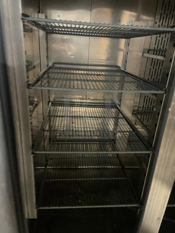 Kelvinator stainless steel 2-door freezer, model KCBM48RSE-HC, with poly-coated wire racks, on casters.