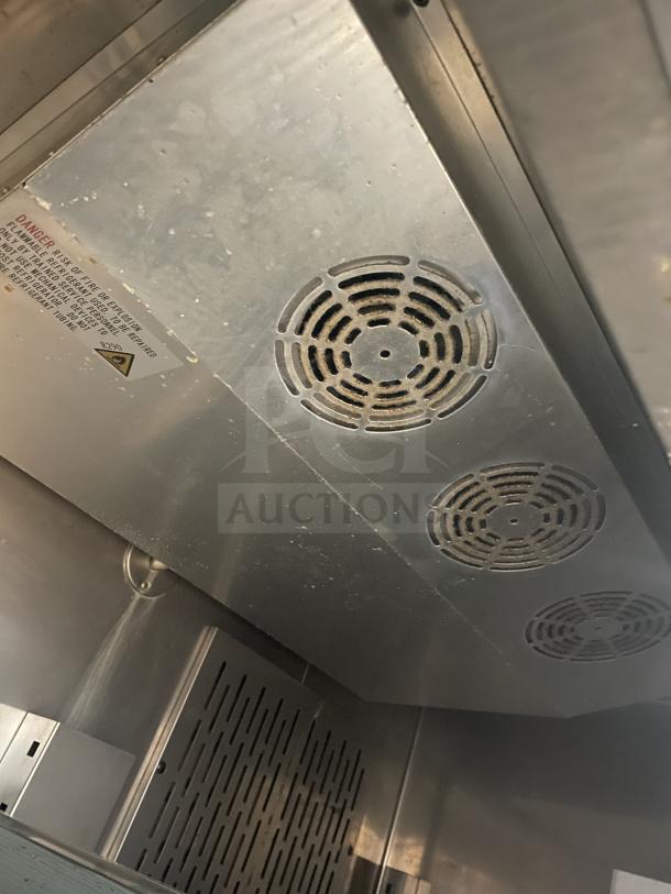 Kelvinator KCBM48RSE-HC commercial stainless steel 2-door freezer interior with poly coated wire rack, model label visible.