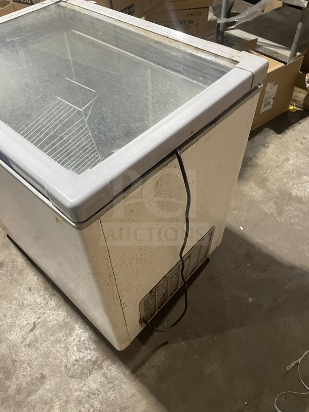 Nordon SDS-250 ice cream dipping cabinet, glass top, metal body, visible wear, size unknown, single power cord.