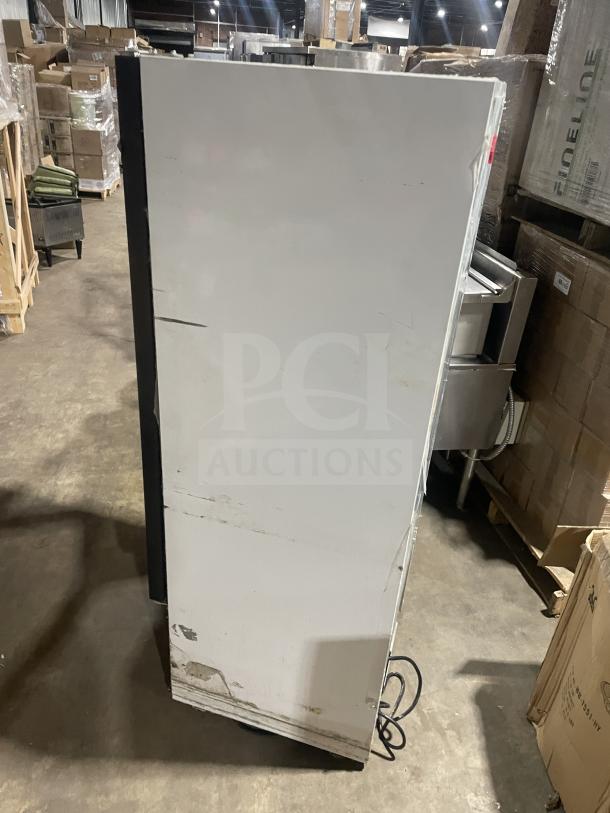 Everest EMGR10 single glass door merchandiser freezer, poly coated wire racks, used condition, side view.