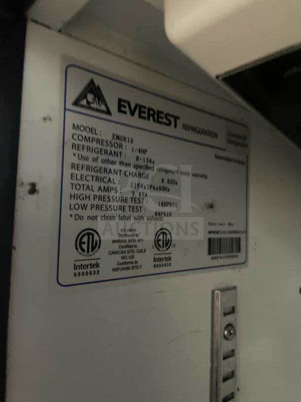 Everest EMGR10 merchandiser freezer label, showing model info, electrical specs, refrigerant charge, and certification stamps.