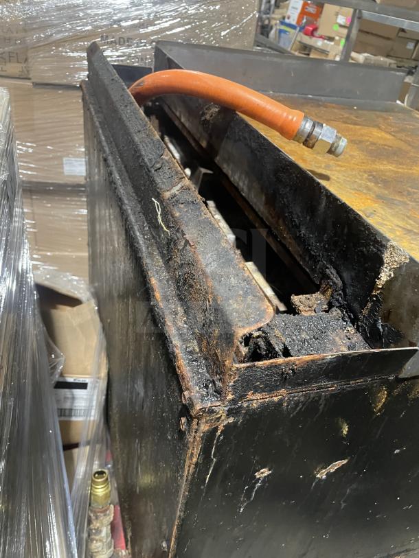 Montague stainless steel gas char broiler grill, model C36SHB, on legs and casters, with visible wear and rust.