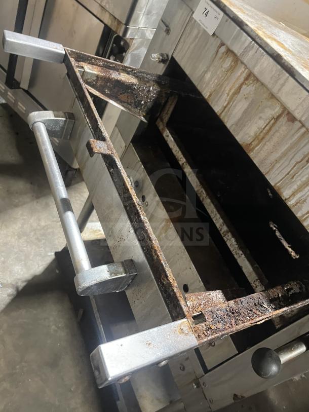 Montague stainless steel gas char broiler grill, Model C36SHB, SN A8-D-73003A, on legs and equipment stand with storage.