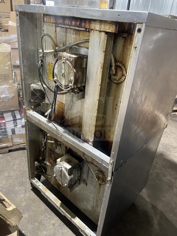 Blodgett commercial stainless steel gas-powered double stacked convection oven, thermostatic controls, wired rack, on casters.