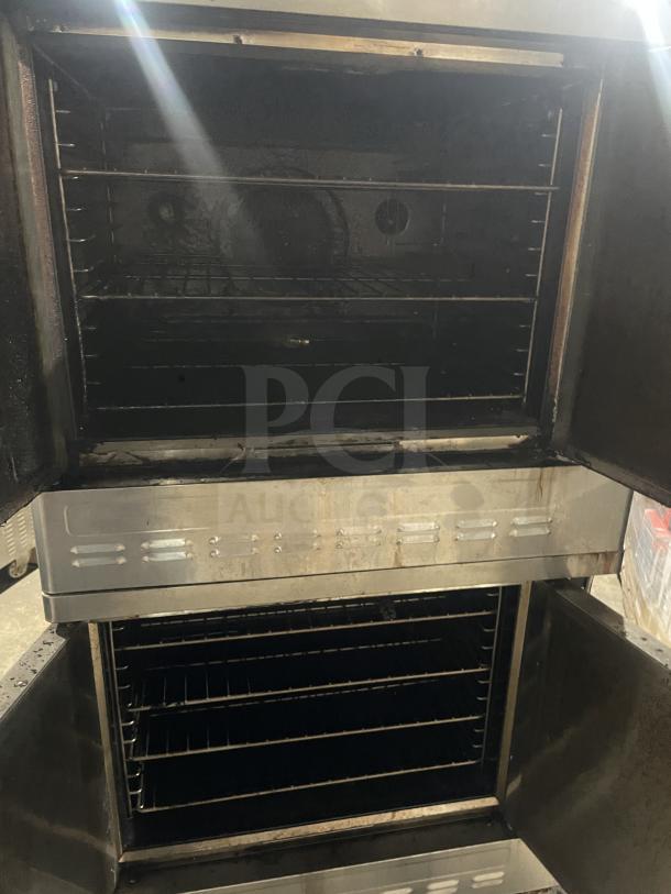 Blodgett stainless steel gas-powered double-stacked convection oven. Features thermostatic controls, wired oven racks, and casters.