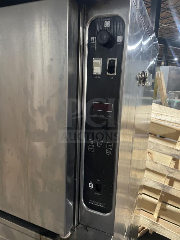 Blodgett stainless steel gas-powered double-stacked convection oven with thermostatic controls and wired rack on casters.