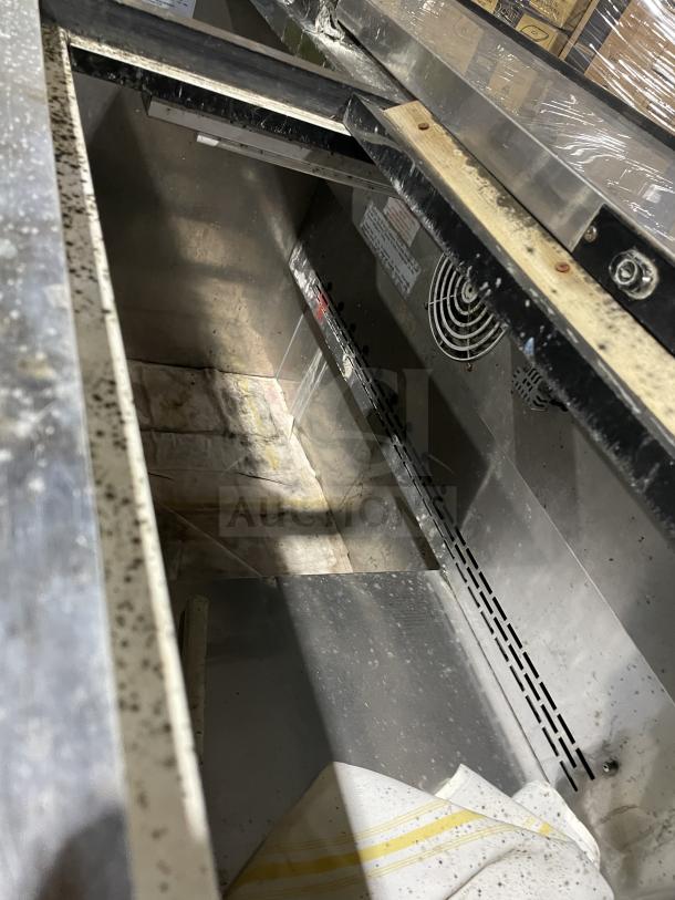 Arctic Air AUB50RZ stainless steel deep well bottle cooler, dual top lids, on casters, 115V, model number visible inside.