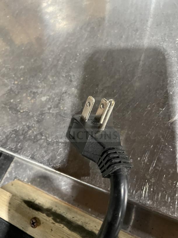 Arctic Air AUB50RZ stainless steel deep well bottle cooler plug. Model and serial number not visible.