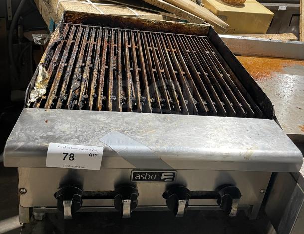 Asber commercial stainless steel gas griddle with side splashes, countertop model on legs. Used condition, visible wear.
