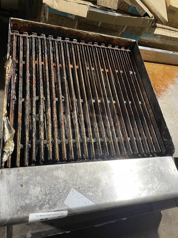 Asber commercial stainless steel countertop gas griddle with side splashes, on legs, showing moderate wear and rust.