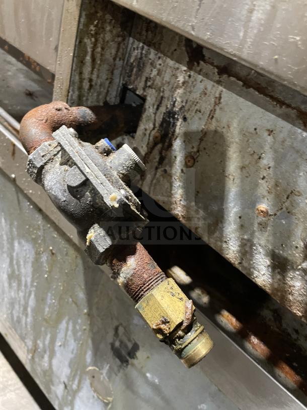 Asber commercial stainless steel gas griddle with side splashes. Rust visible, needs cleaning. On legs, industrial-grade.