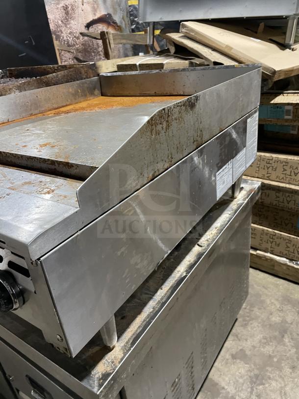 American Range stainless steel commercial griddle, model AETG-124-24XT. Natural gas, back and side splash, on casters.