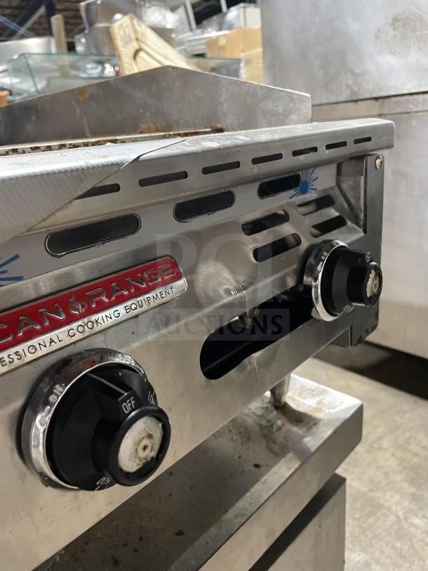 American Range stainless steel countertop flat griddle, Model AETG-124-24XT, natural gas, with back and side splash, on casters.