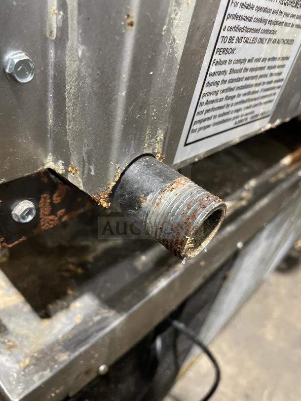 American Range stainless steel flat griddle, model AETG-124-24XT. Natural gas, good condition, with back and side splash.