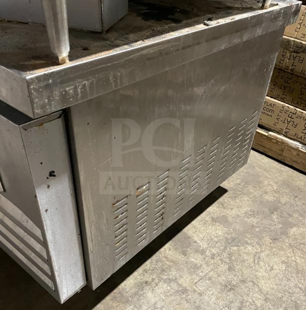 Kelvinator stainless steel refrigerated chef base, model KCHCB48R, with two drawers, on casters. Shows usage wear.