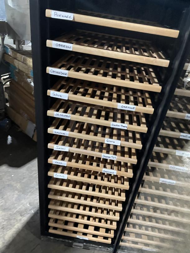 Eurodib USF-1688 single door wine cooler, wooden shelves labeled with wine names, black exterior, commercial use.